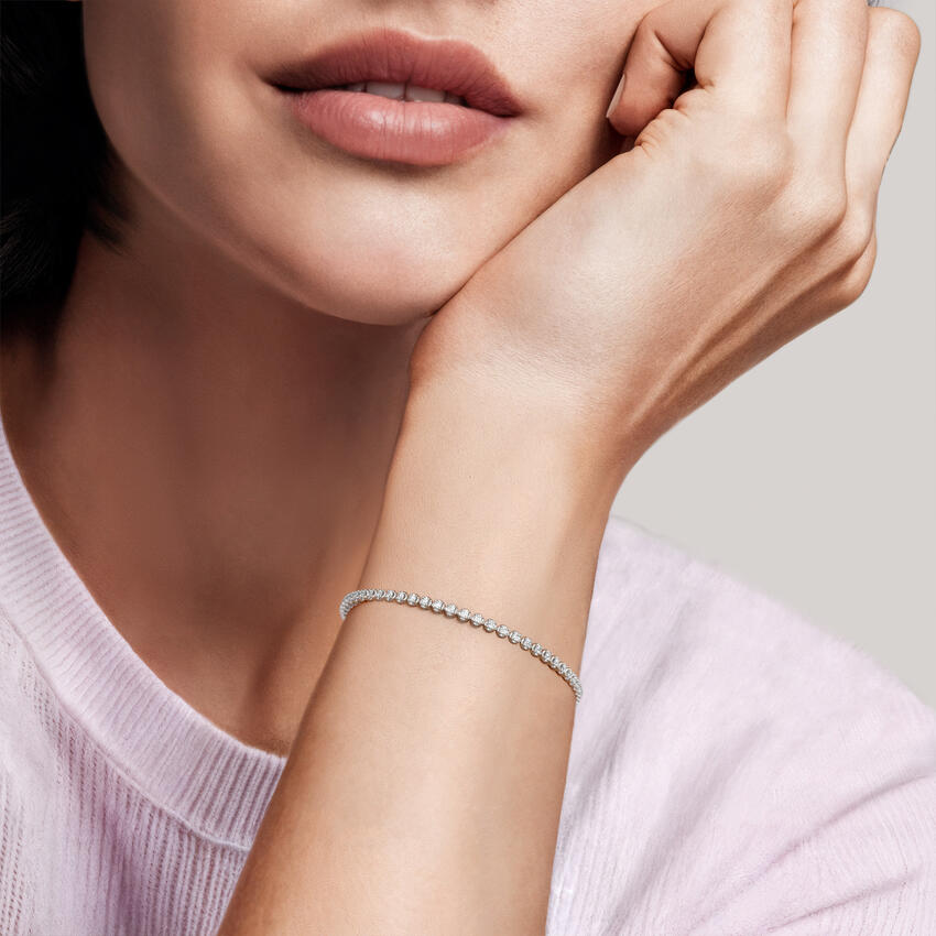 Lab-grown diamond tennis bracelet styled on a model's wrist