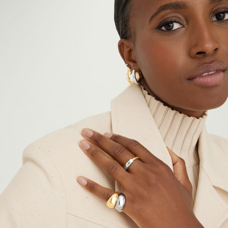 Woman wearing mixed metal gold and silver stacking rings on hand