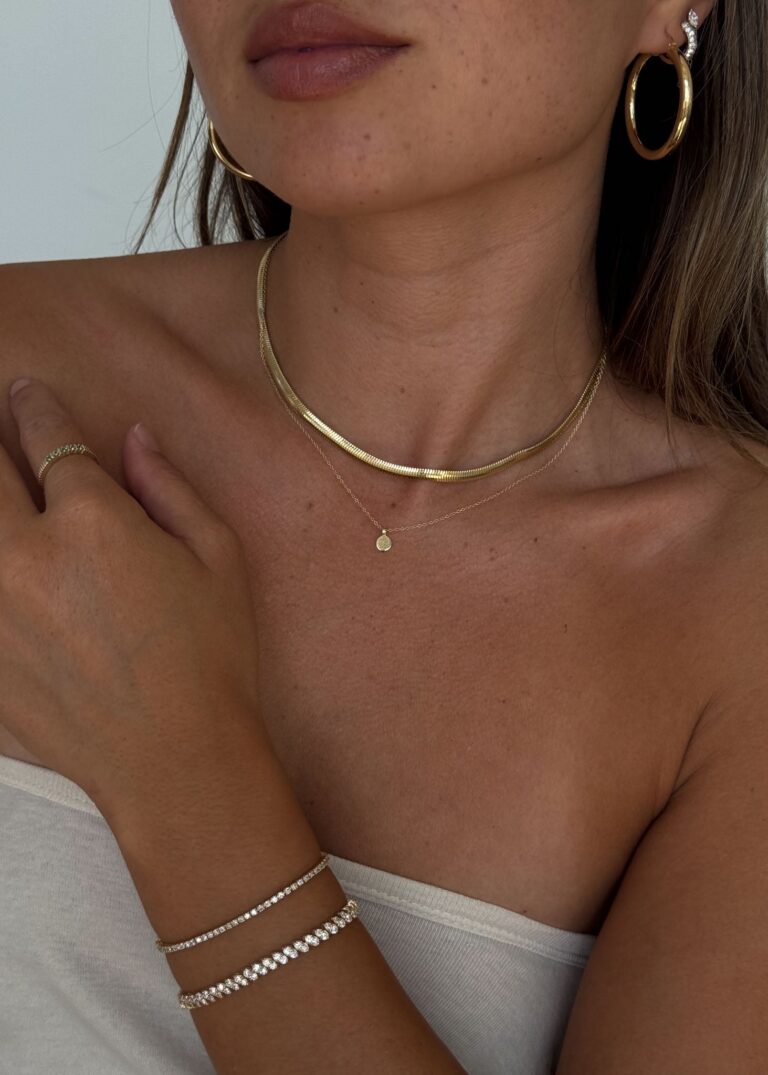 Model wearing 14k gold classic hoop earrings