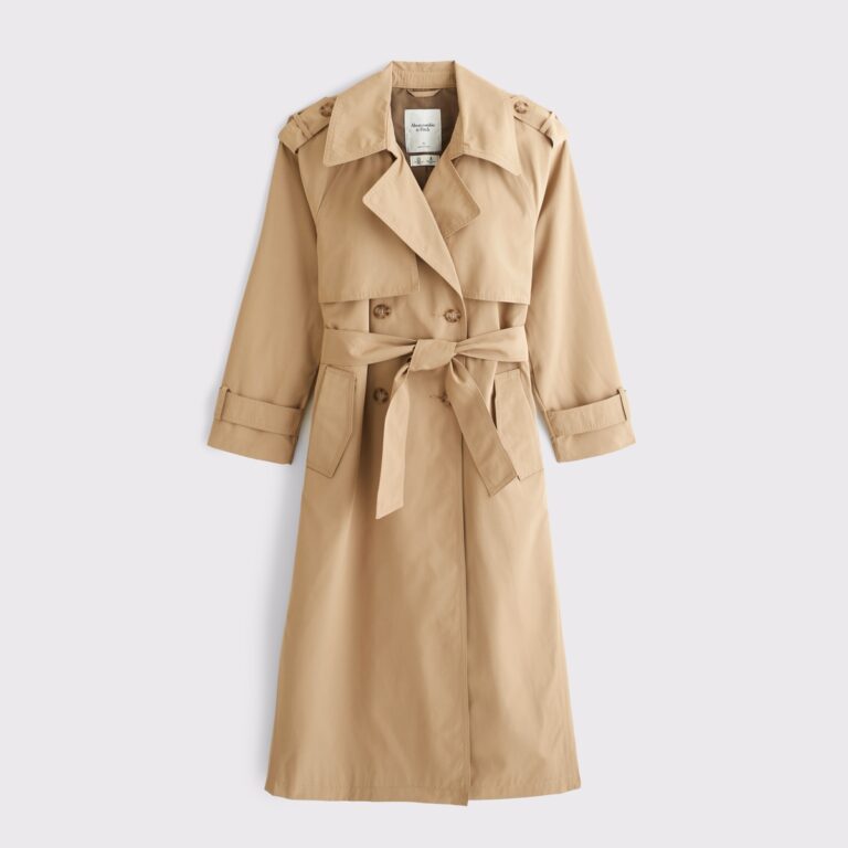 Woman wearing a long beige lightweight trench coat for fall